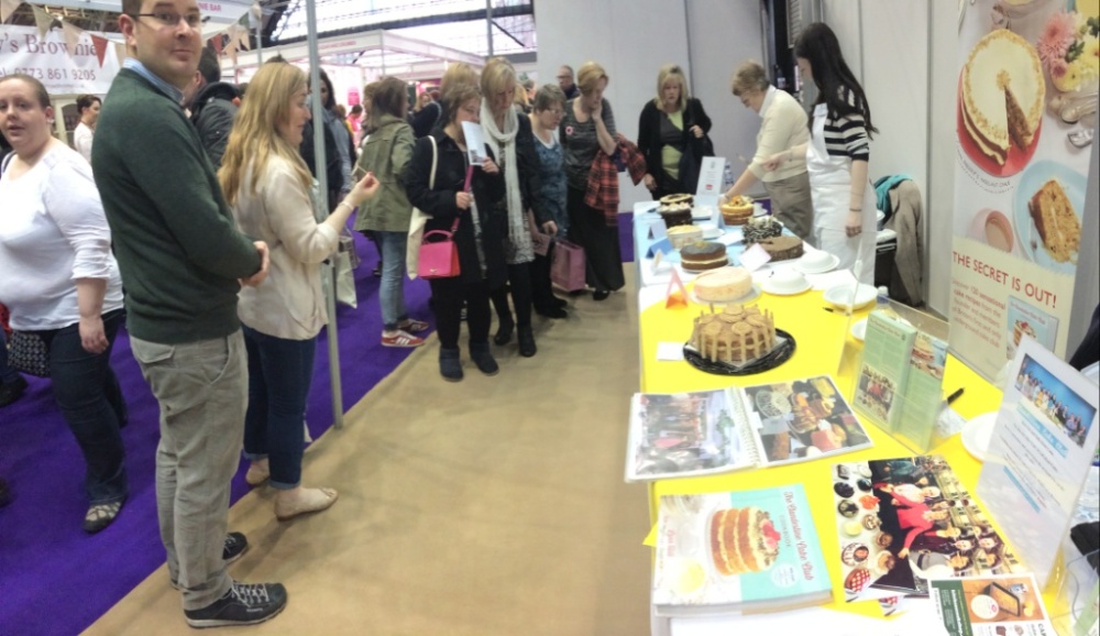 clandestine cake club stall at cake and bake show 2014 crowds gathering for taste on the table judging